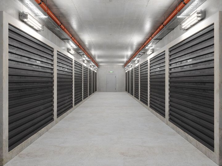 View of rows of self-storage- climate-controlled- units with white doors.