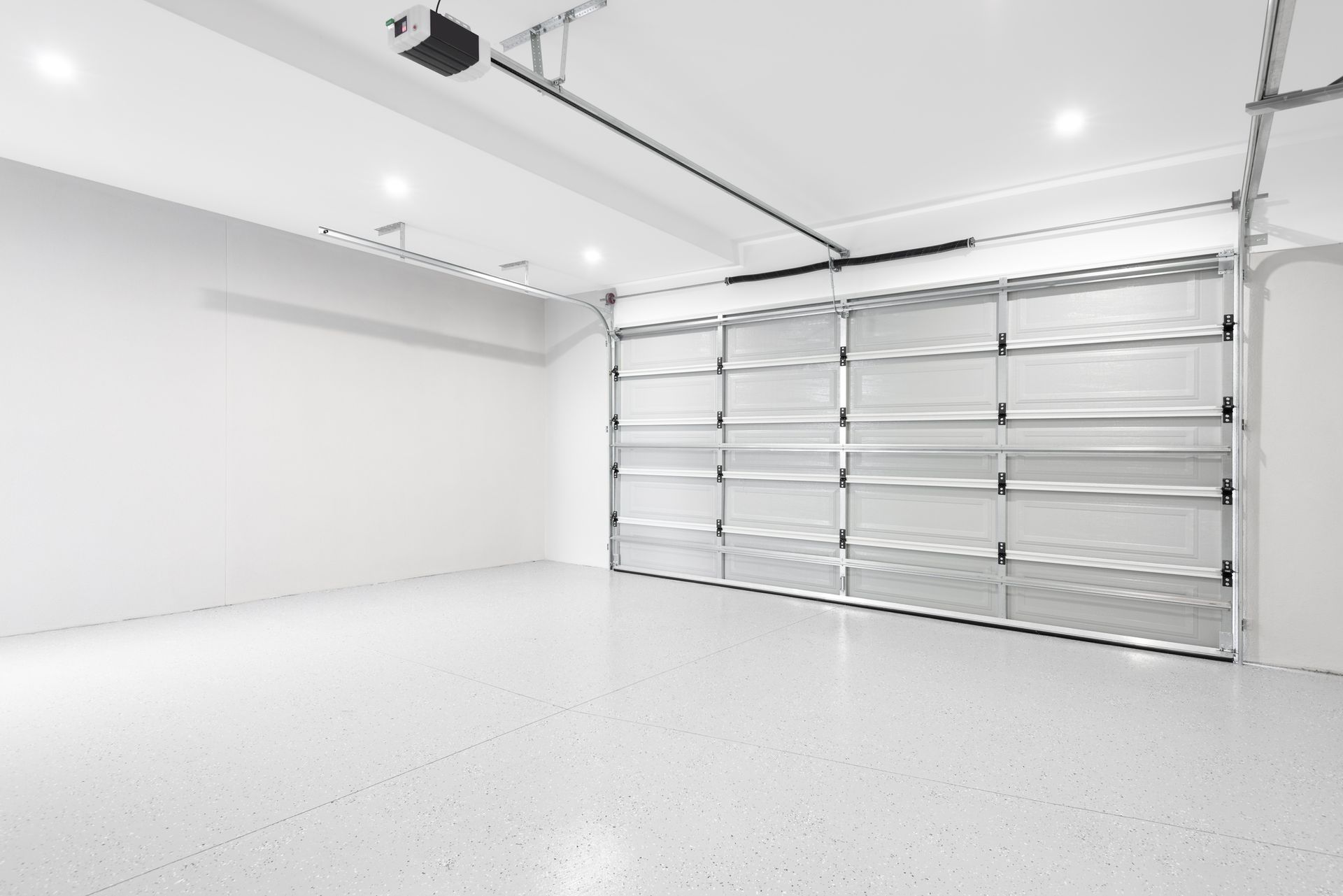 Empty white garage with a clear glass door.