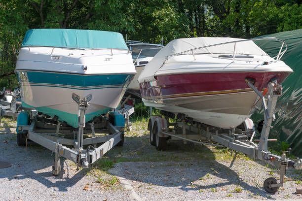 Two motorboats on trailers in a boat storage facility.