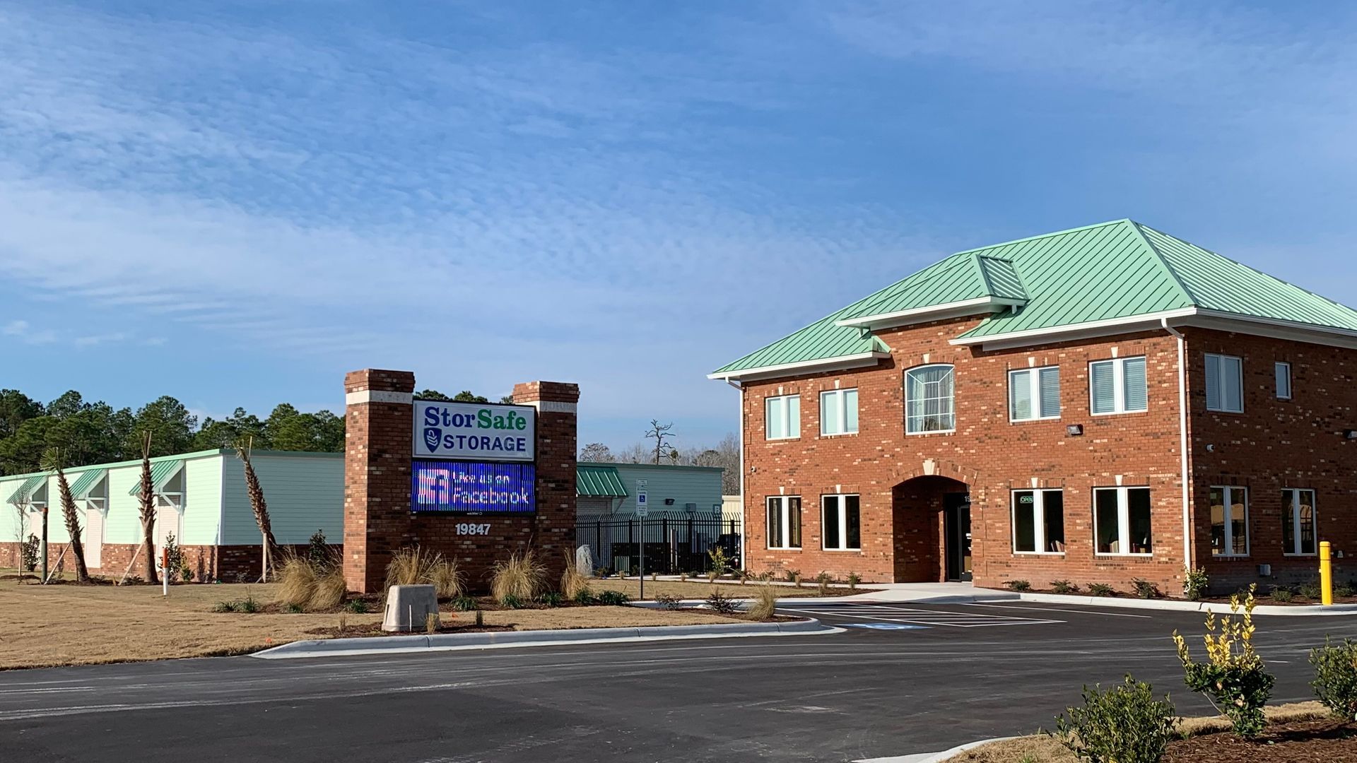 Brick building with green roof, sign for