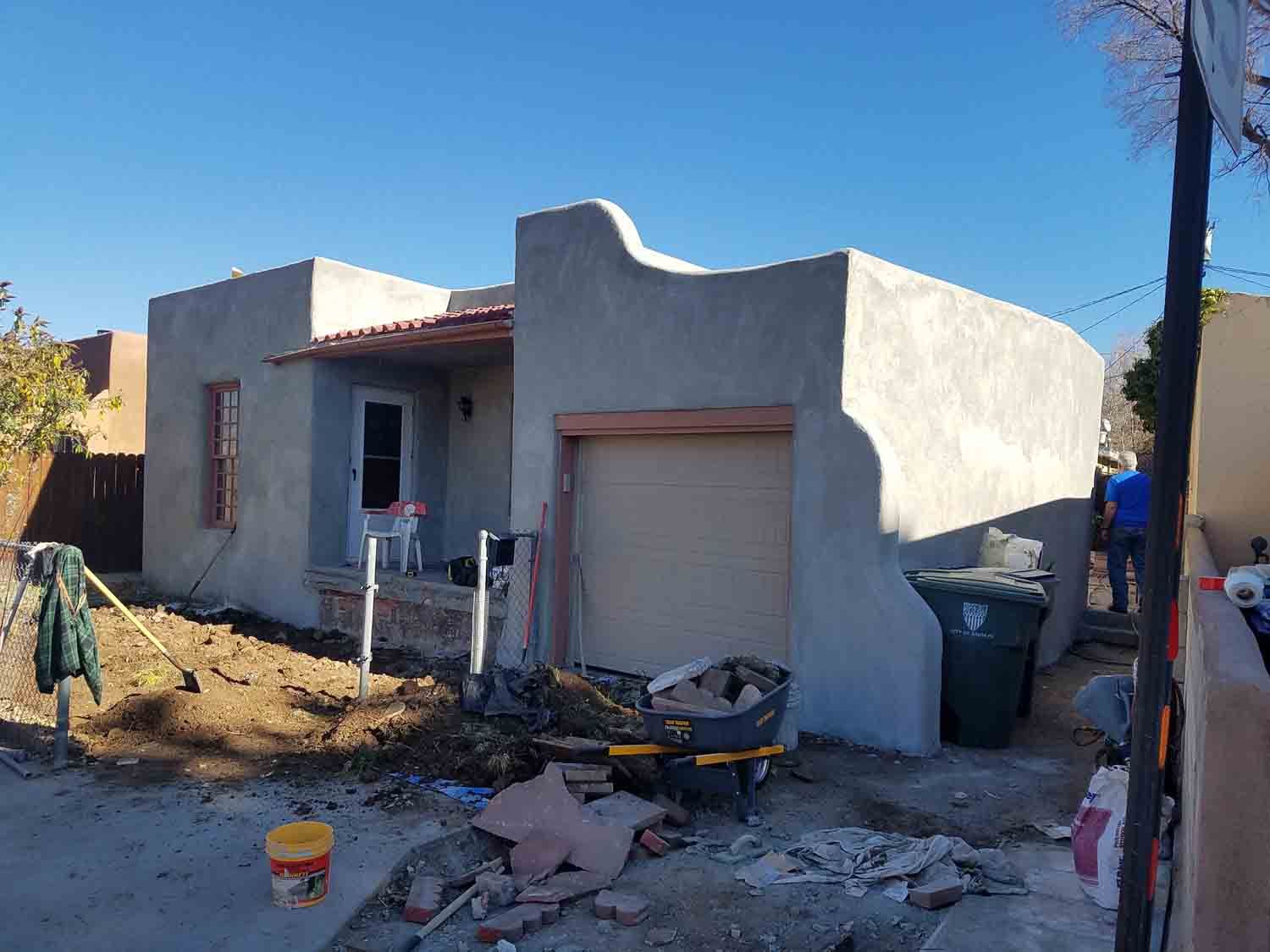 A house with a garage door is being remodeled.