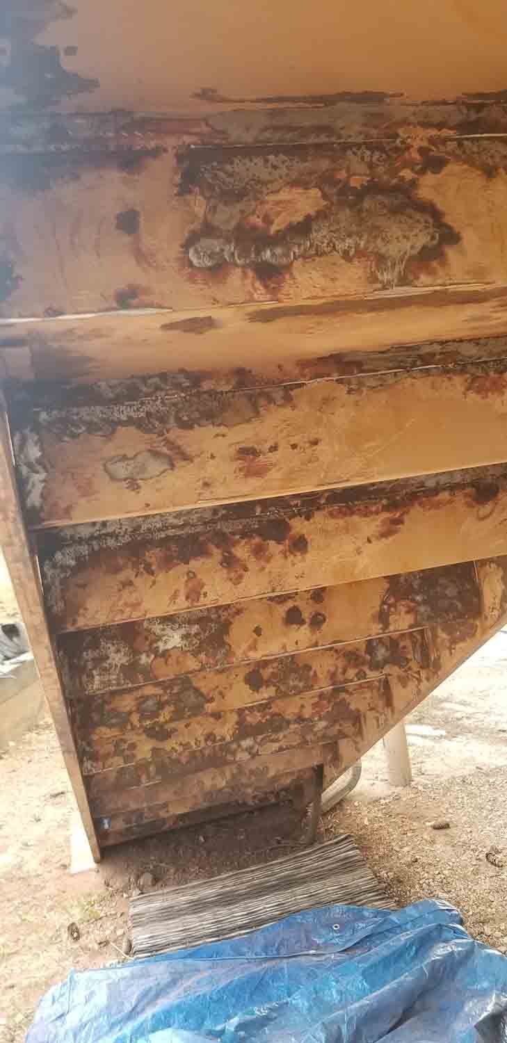 A close up of a wooden staircase with peeling paint.