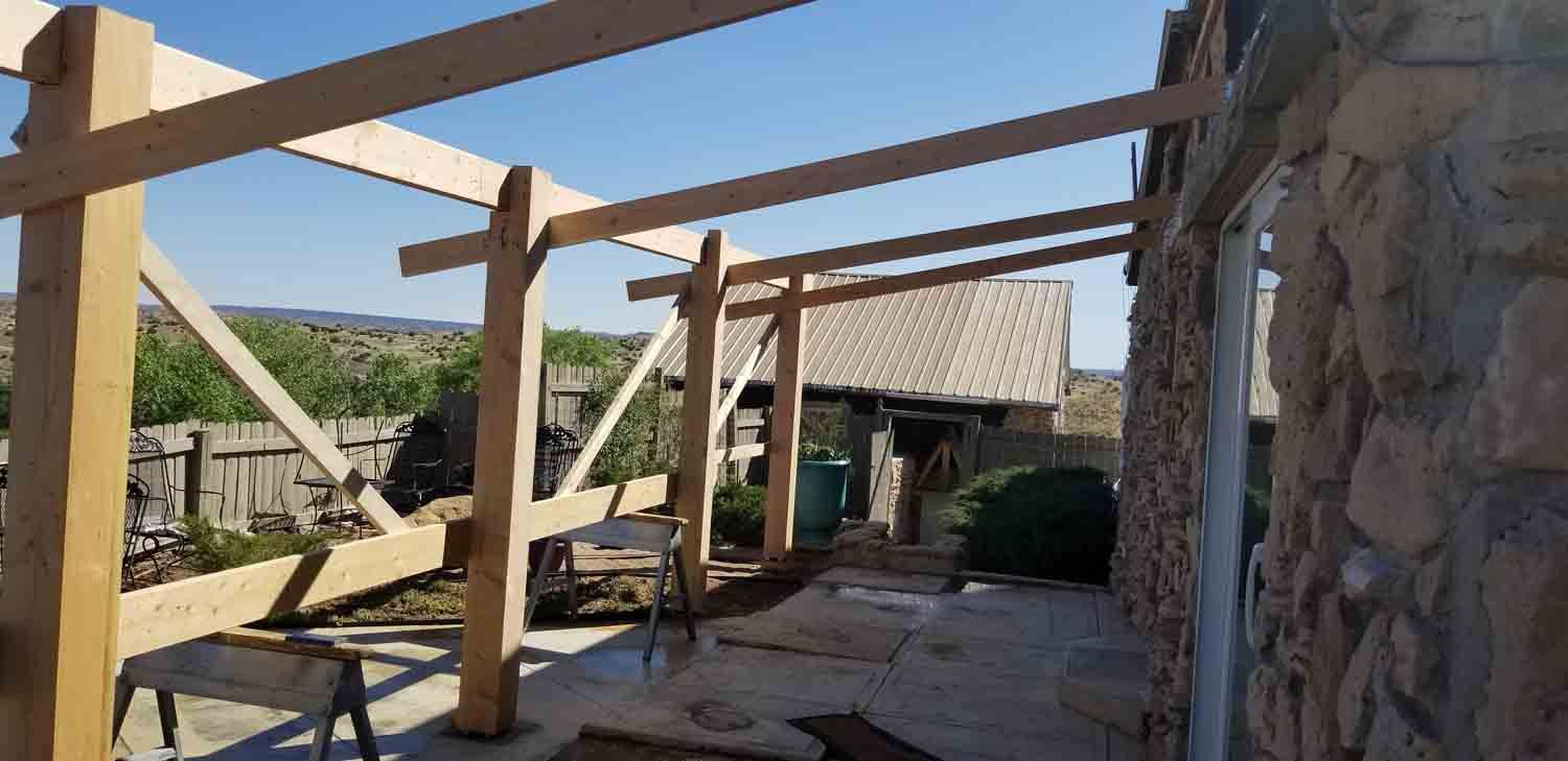 A wooden structure is being built on the side of a building.