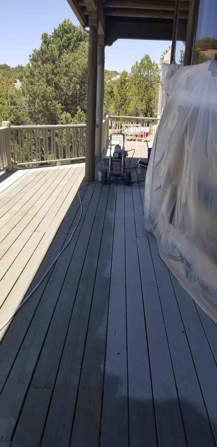 A wooden deck with a lawn mower on it.