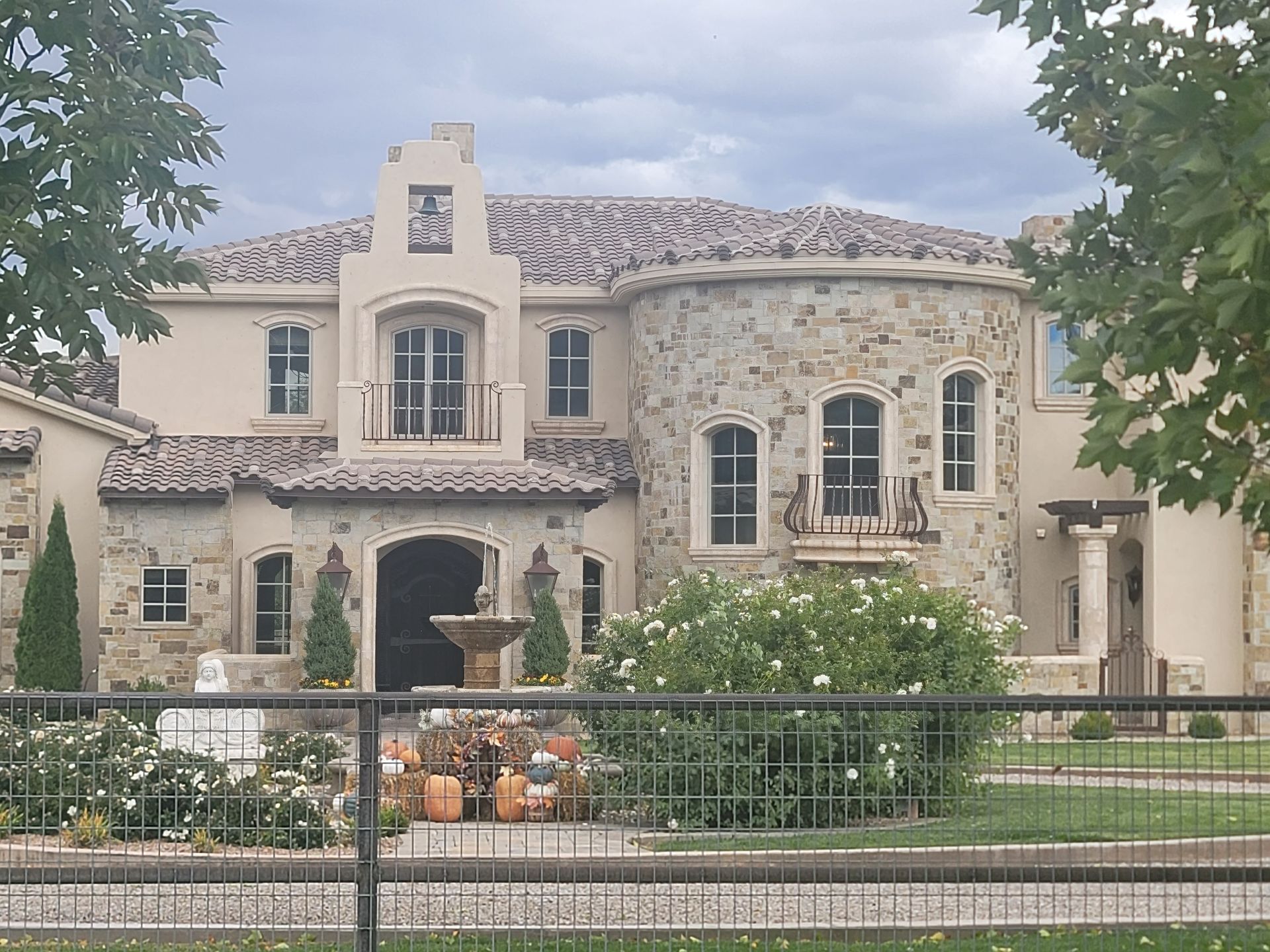 A large house with a fence in front of it