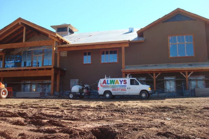 A always van is parked in front of a large building under construction.