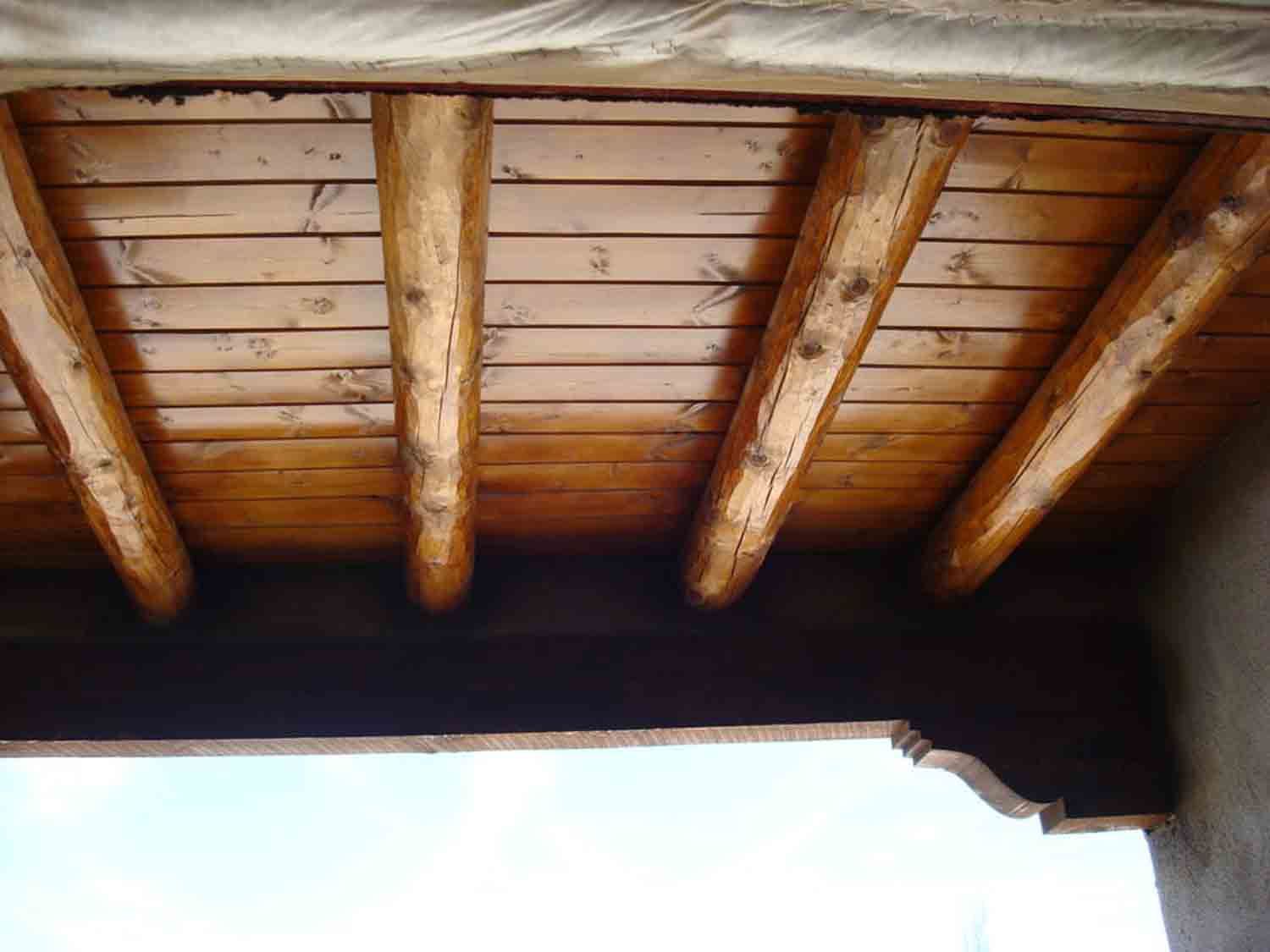 The ceiling of a building is made of wooden beams.