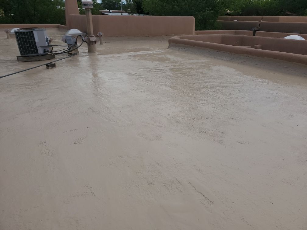 A rooftop with a fan and a satellite dish on it.