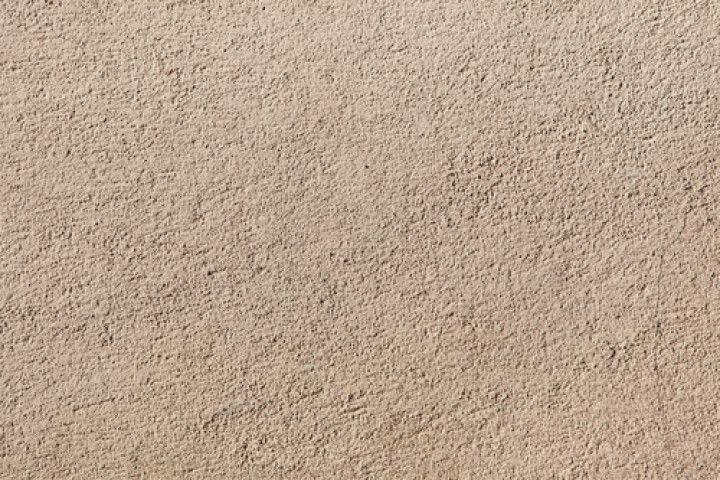 A close up of a sandy surface with a grainy texture.