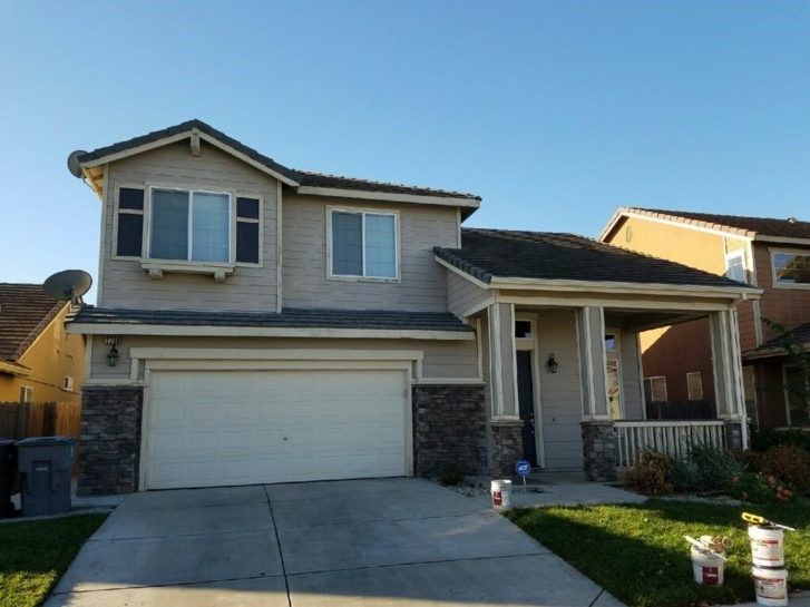 A house with a white garage door and a porch