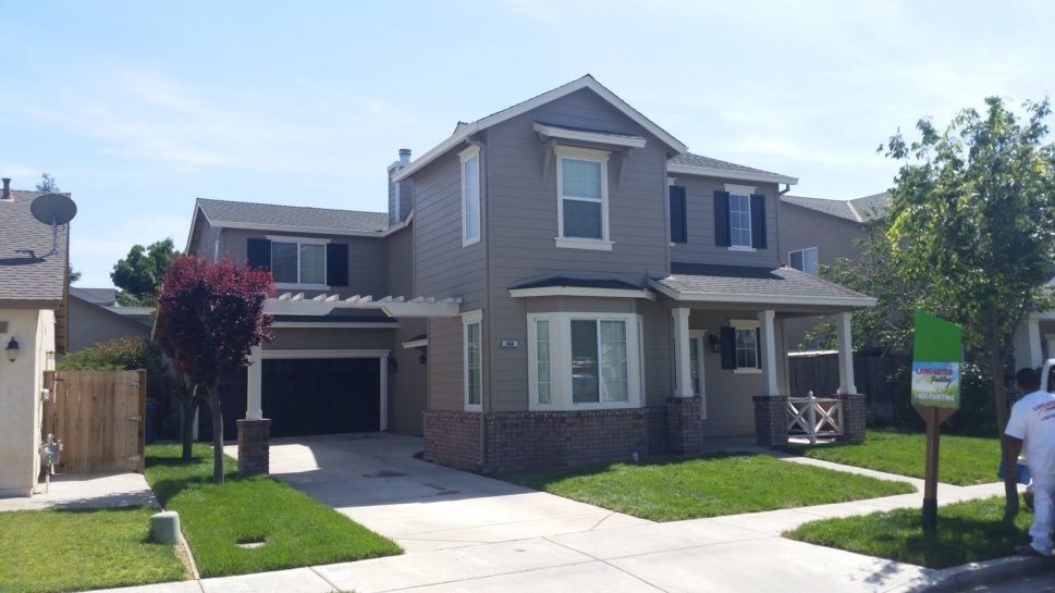 A house with a for sale sign in front of it