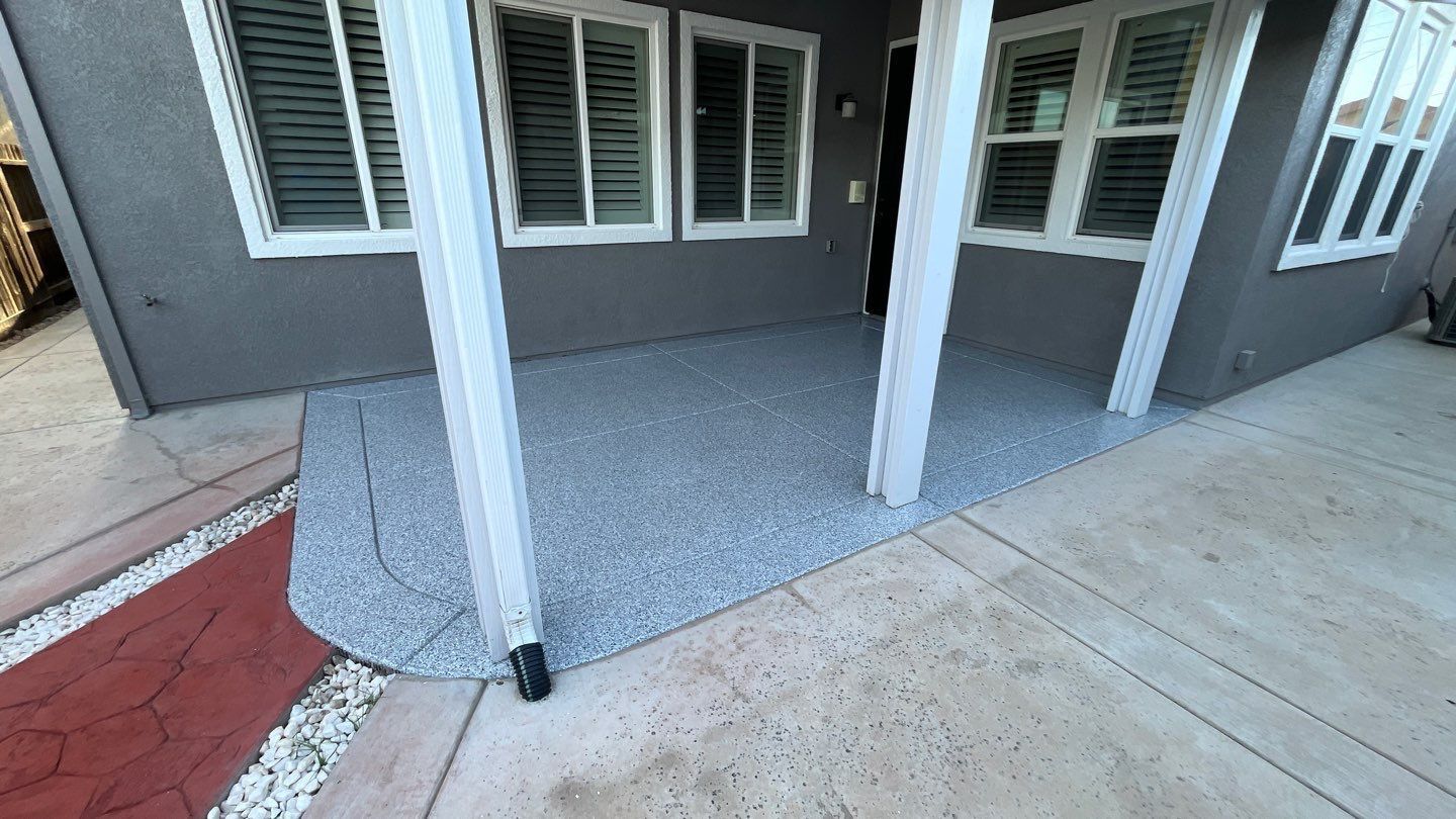 A house with a porch and a concrete floor.