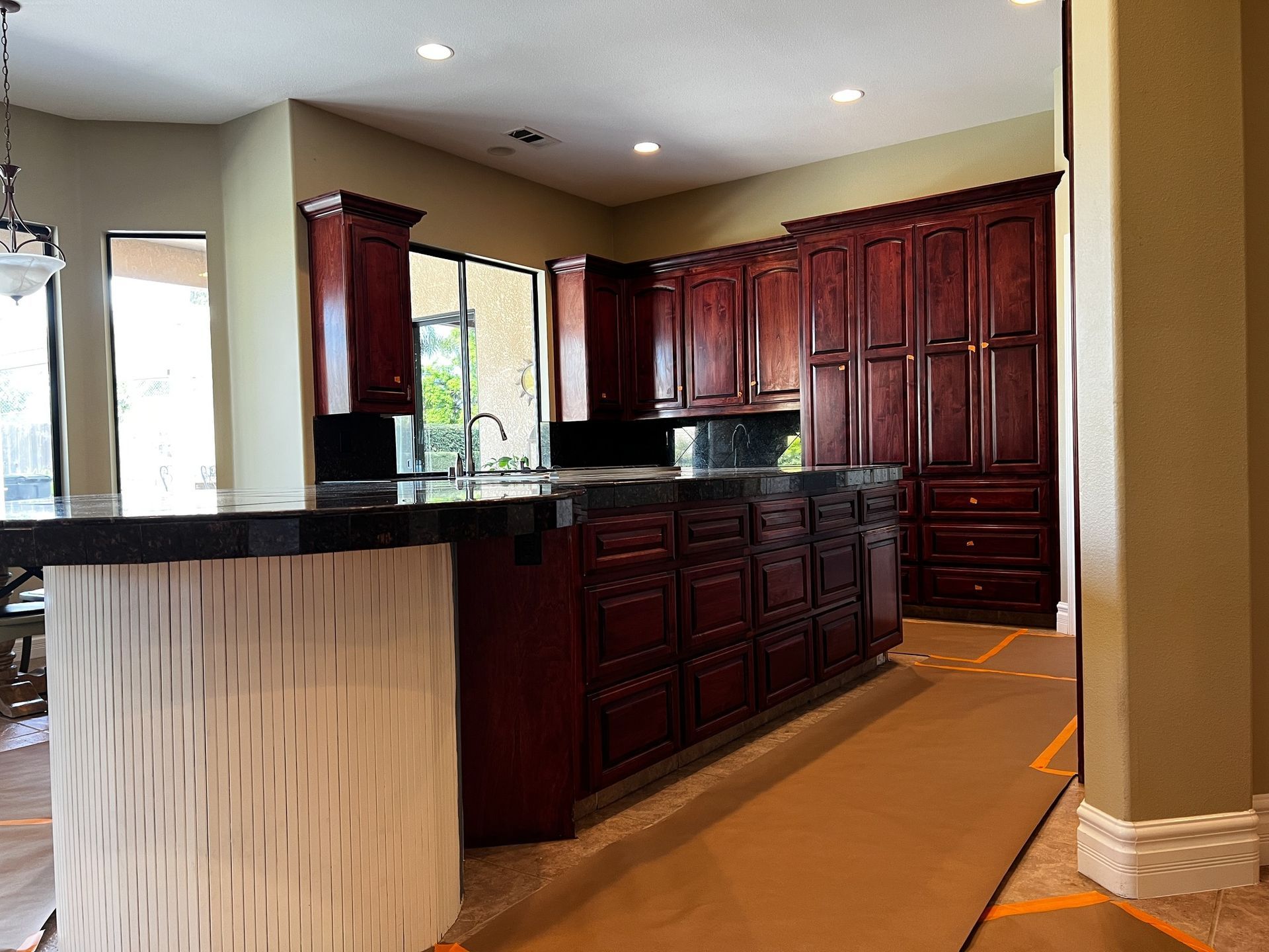 A kitchen with wooden cabinets and granite counter tops