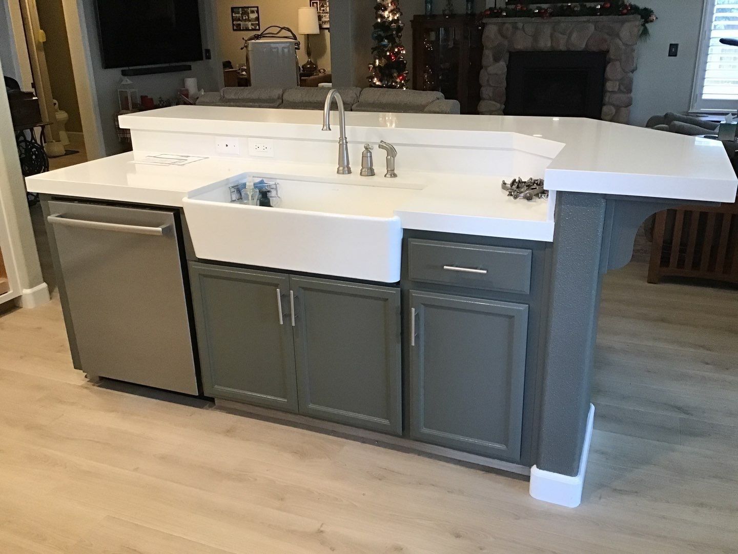 A kitchen with a sink , dishwasher , and stainless steel appliances.