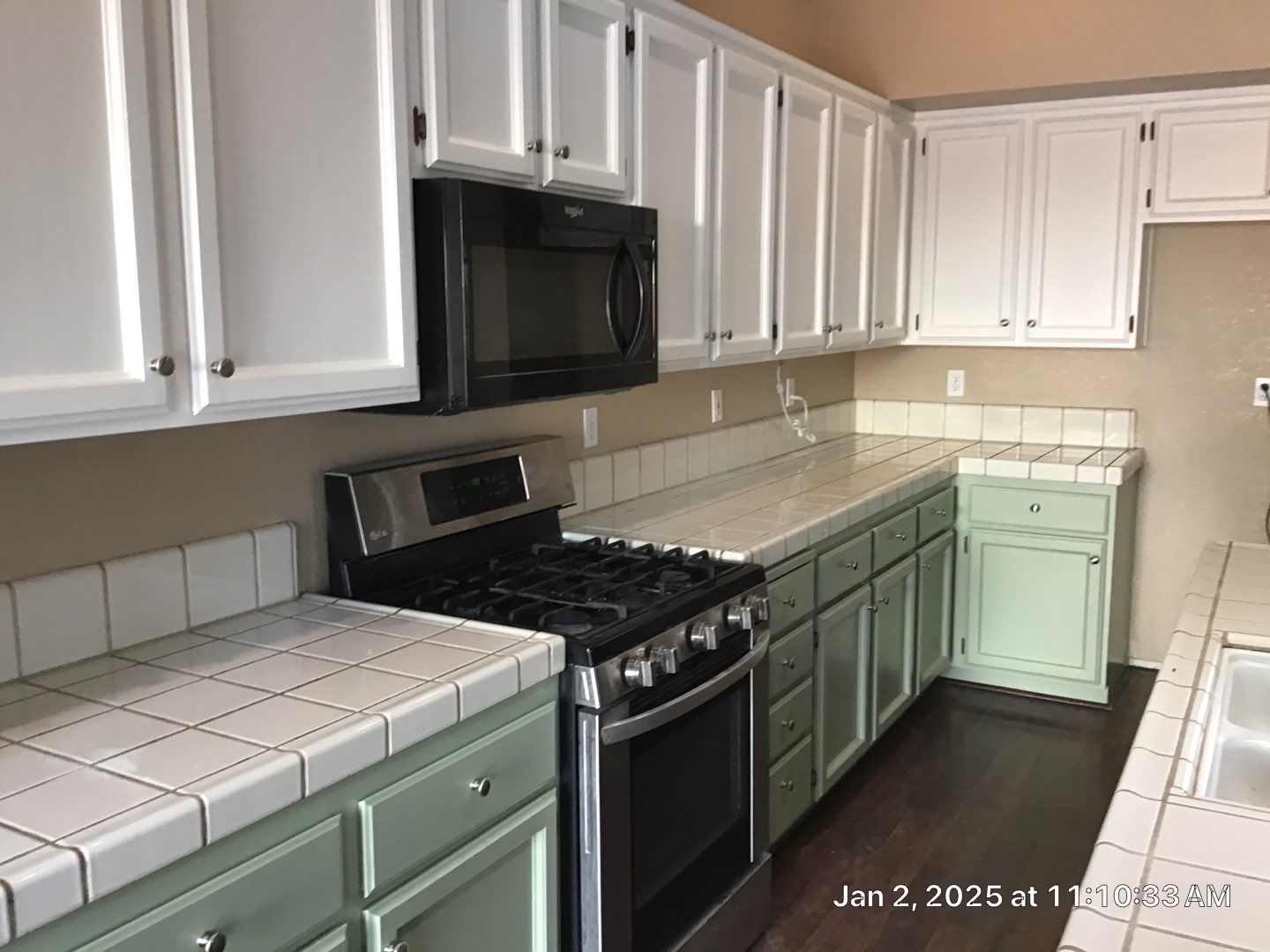 Cabinet painting photo with green and white cabinets 
