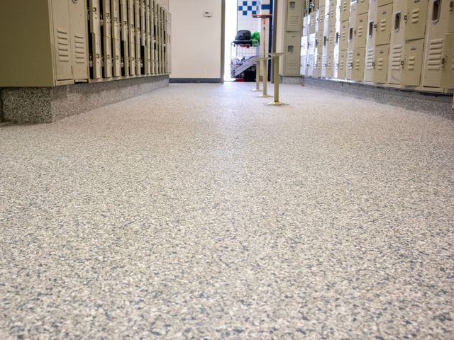 A row of lockers are lined up in a hallway.
