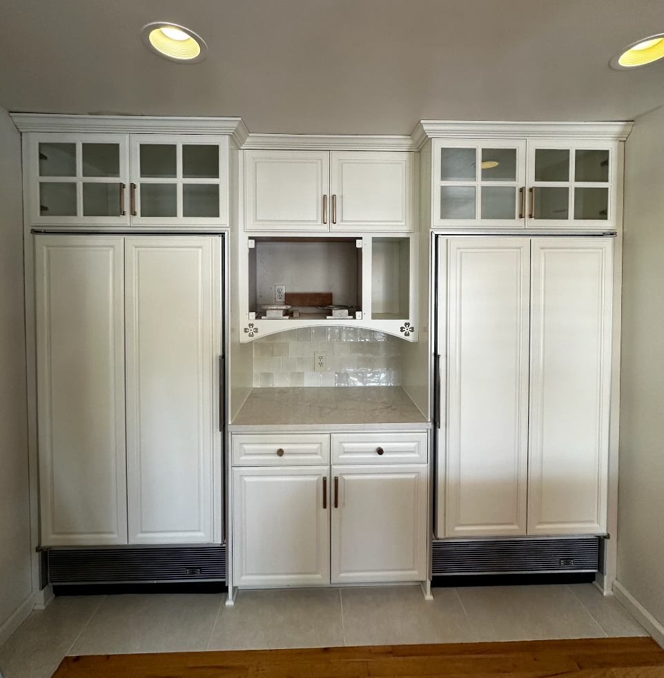 Kitchen cabinets after being painted white 