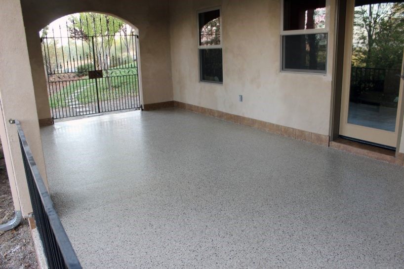 A patio with a fence and a sliding glass door