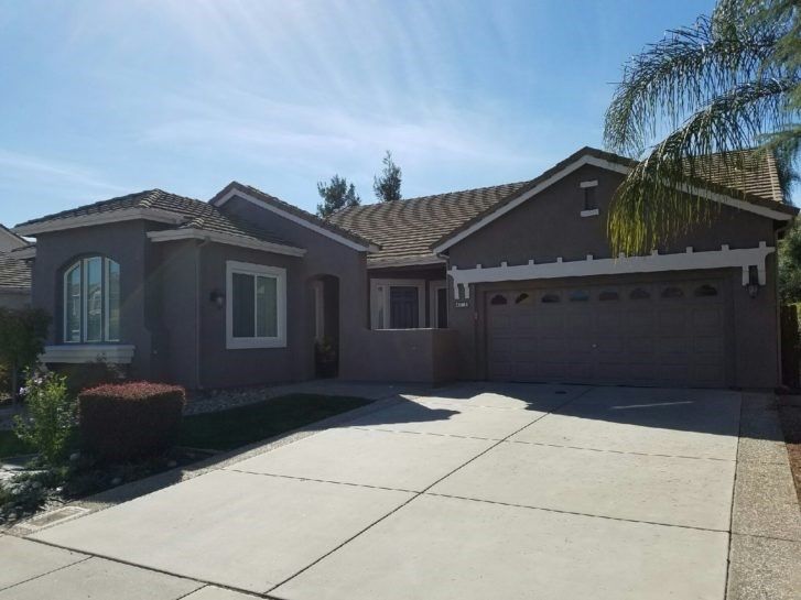 A house with a garage and a driveway in front of it