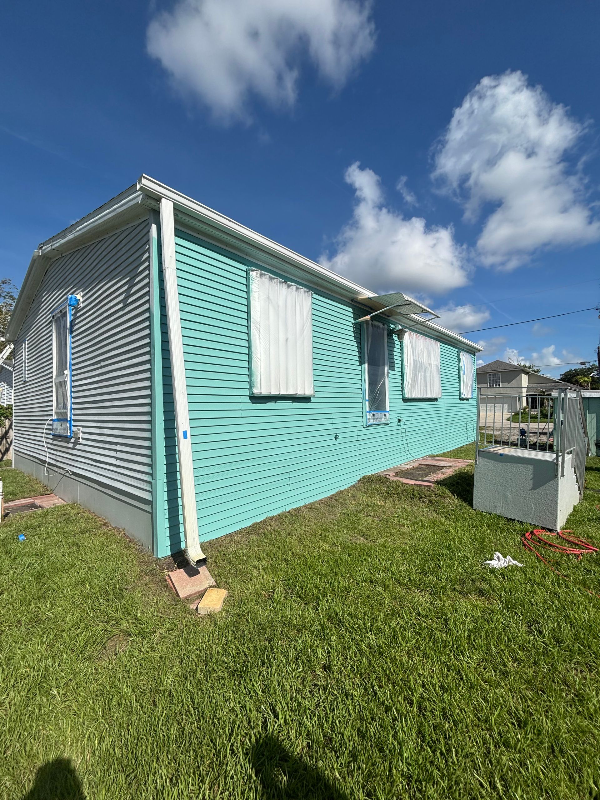 Sherwin-Williams Emerald VinylSafe exterior repaint on vinyl siding home