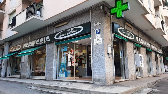 A pharmacy is located on the corner of a building.
