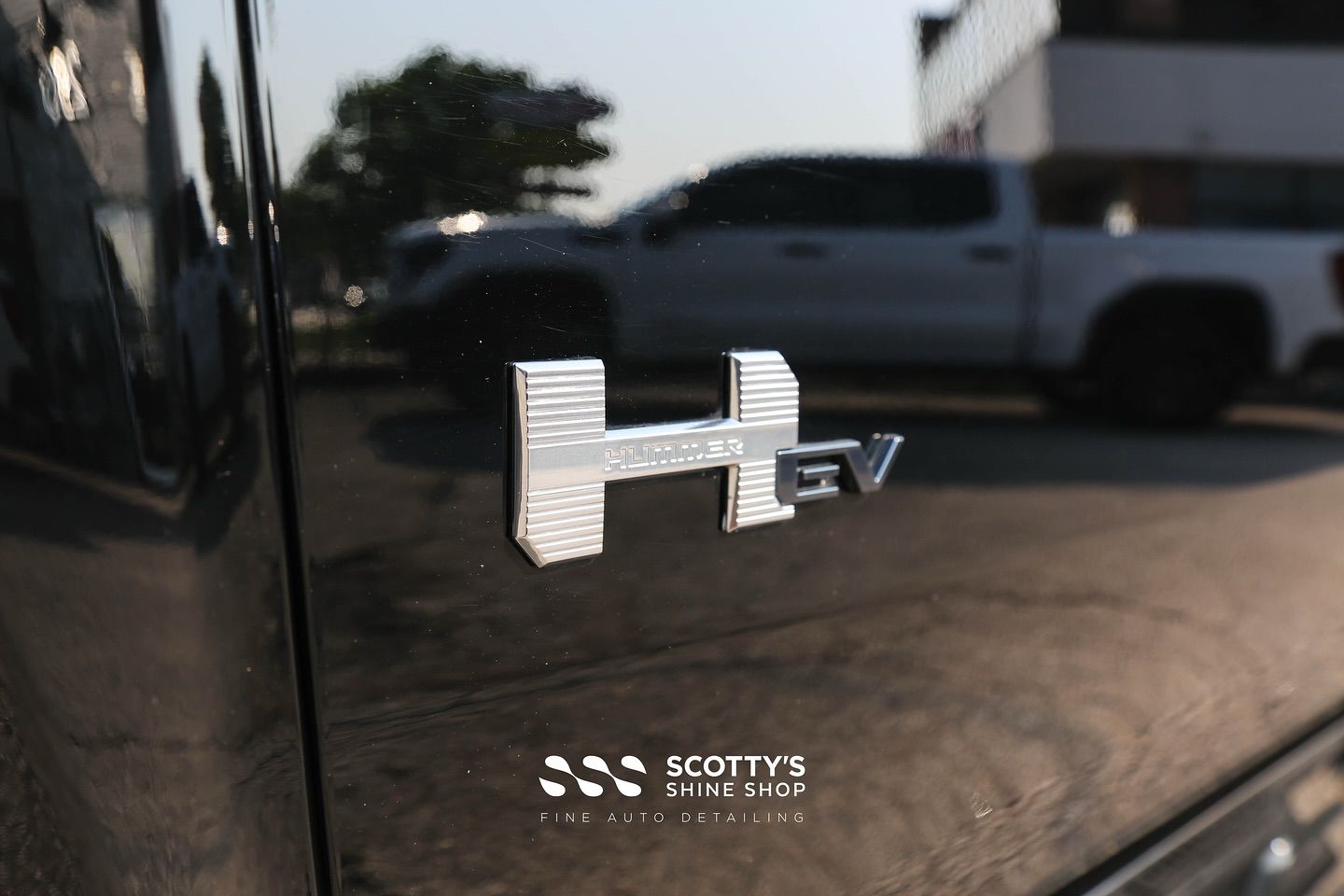 2025 GMC Hummer EV Light Paint Correction, PREMIUM LLumar Formula 1 Stratos Ceramic Window Tint emblem close up, London, Canada