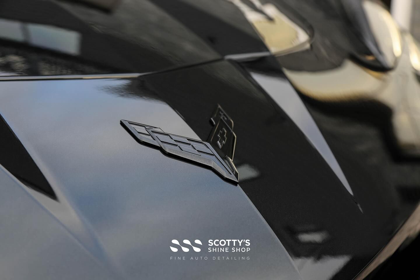 Chevrolet Corvette C8 Xpel Paint Protection Film, Paint Correction, Xpel Prime XR Plus Window Tint and Xpel Fusion Ceramic Coatings on the Wheels, Body and Glass hood emblem close up London, ON