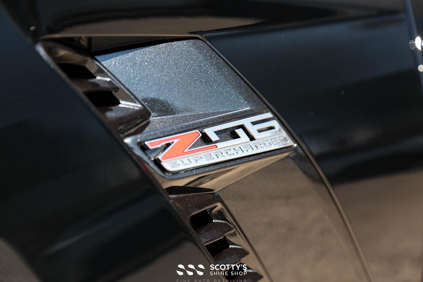 Corvette Z06 paint correction xpel Ultimate Plus paint protection film and modesta BC-04 and BC-06 glass coatings applied to the body and wheels emblem detail London ON