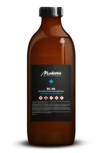 Brown bottle with black cap and dark label on white background