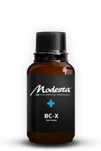 Amber bottle labeled “Modesta BC-X” with a black cap on a white background