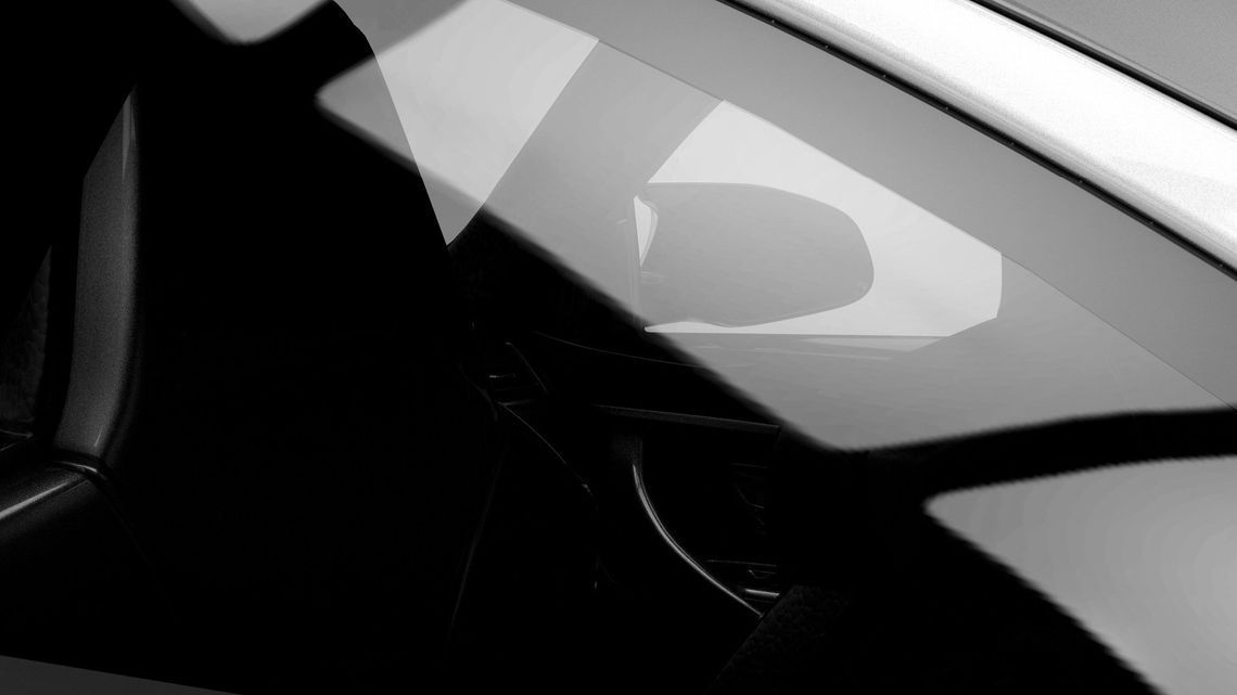Close-up of a black car window and roof with bright reflections on the glass