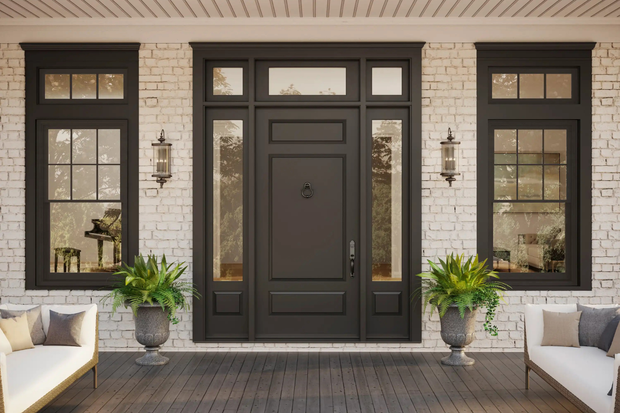 Black front door with sidelights and transom, flanked by windows on a brick facade.