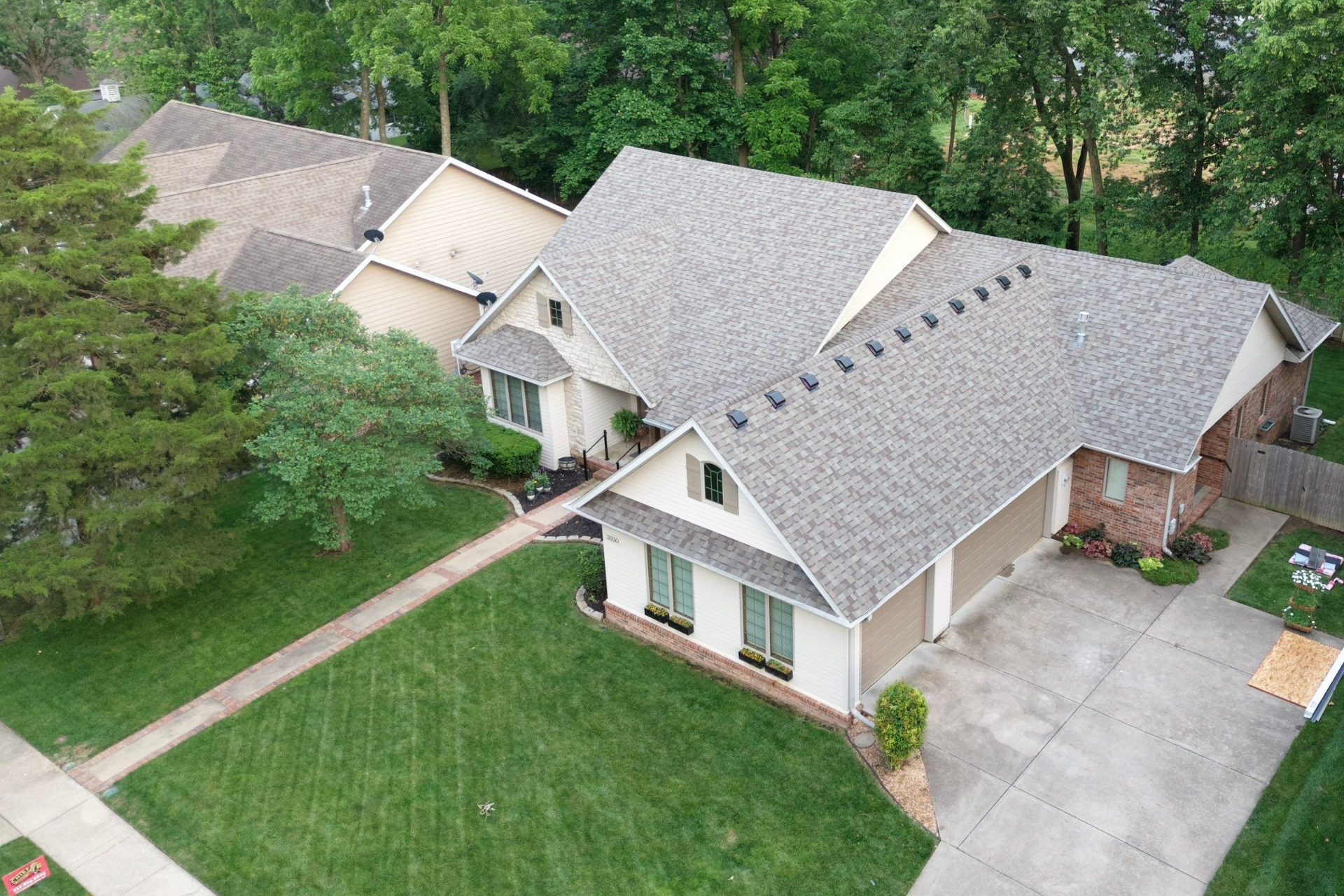 A teal range stove centered in a kitchen with gray cabinets, white tile backsplash, and wooden shelves.