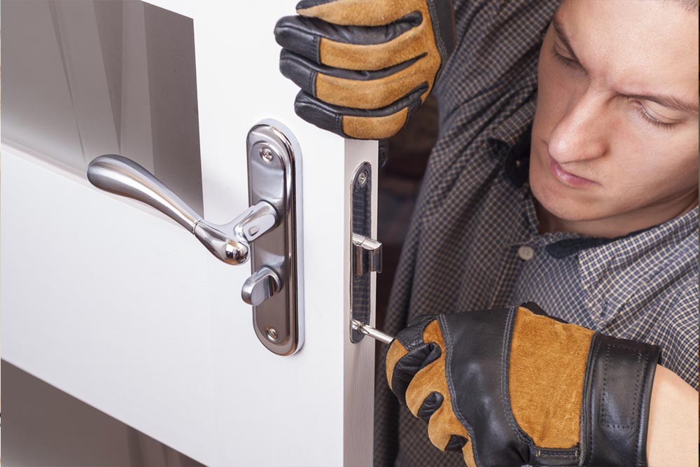 Man conducting door replacement with screw driver in sunshine coast