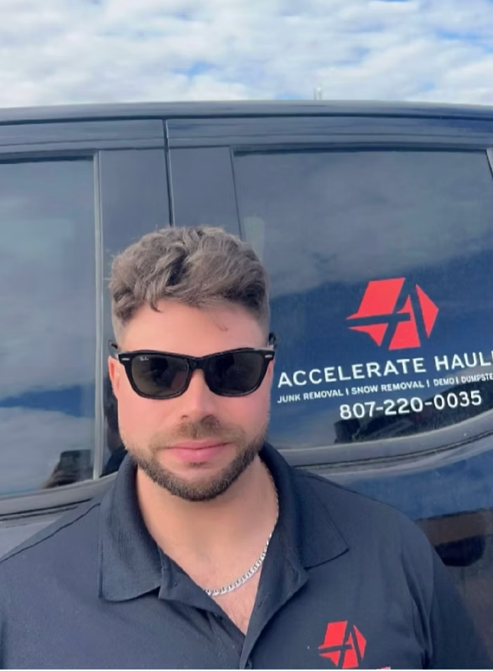 Man in sunglasses stands by a truck with
