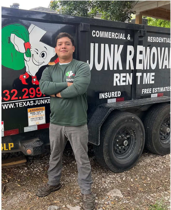 Tony Nava standing in front of a junk removal dumpster, arms crossed.