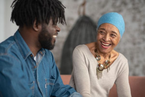 son laughting with mother who has cancer