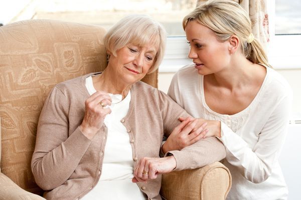 daughter offering emotional support to mother