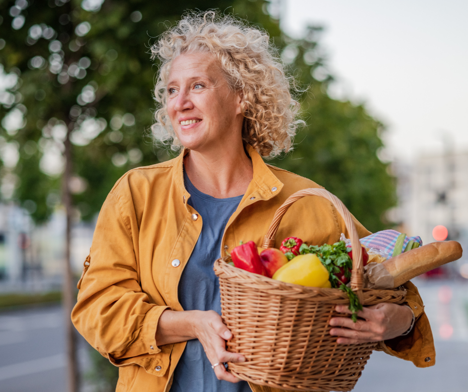 Woman carrying basket of fresh, healthy food