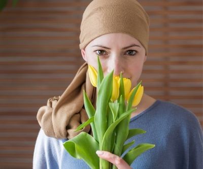 female cancer patient smelling flowers