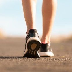 close up of a females feet walking in track shoes