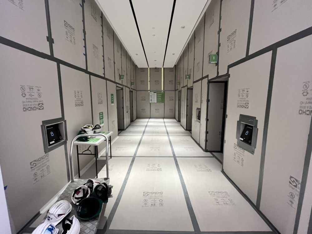 Honcho Chief Board protecting a lift lobby for Renascent