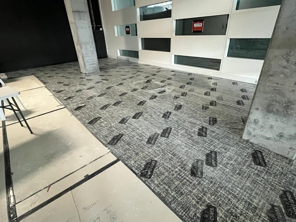 Skudo Carpet Cover protecting carpet in a commercial lobby area - Hutchinson