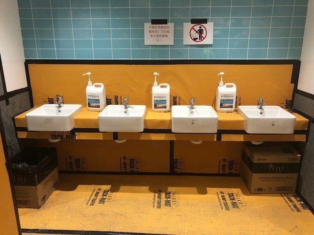 Skudo HT Tack Mat protecting tiles in a commercial bathroom during construction works - Taylor