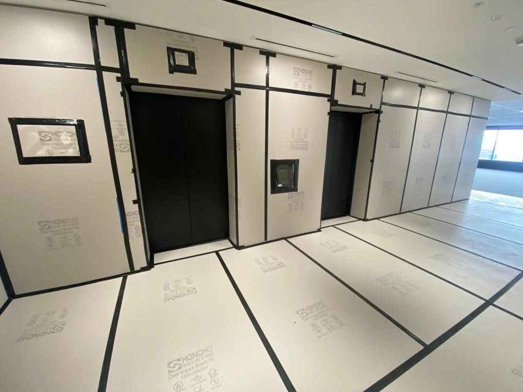 Honcho Chief Board HD protecting a lift lobby for Renascent