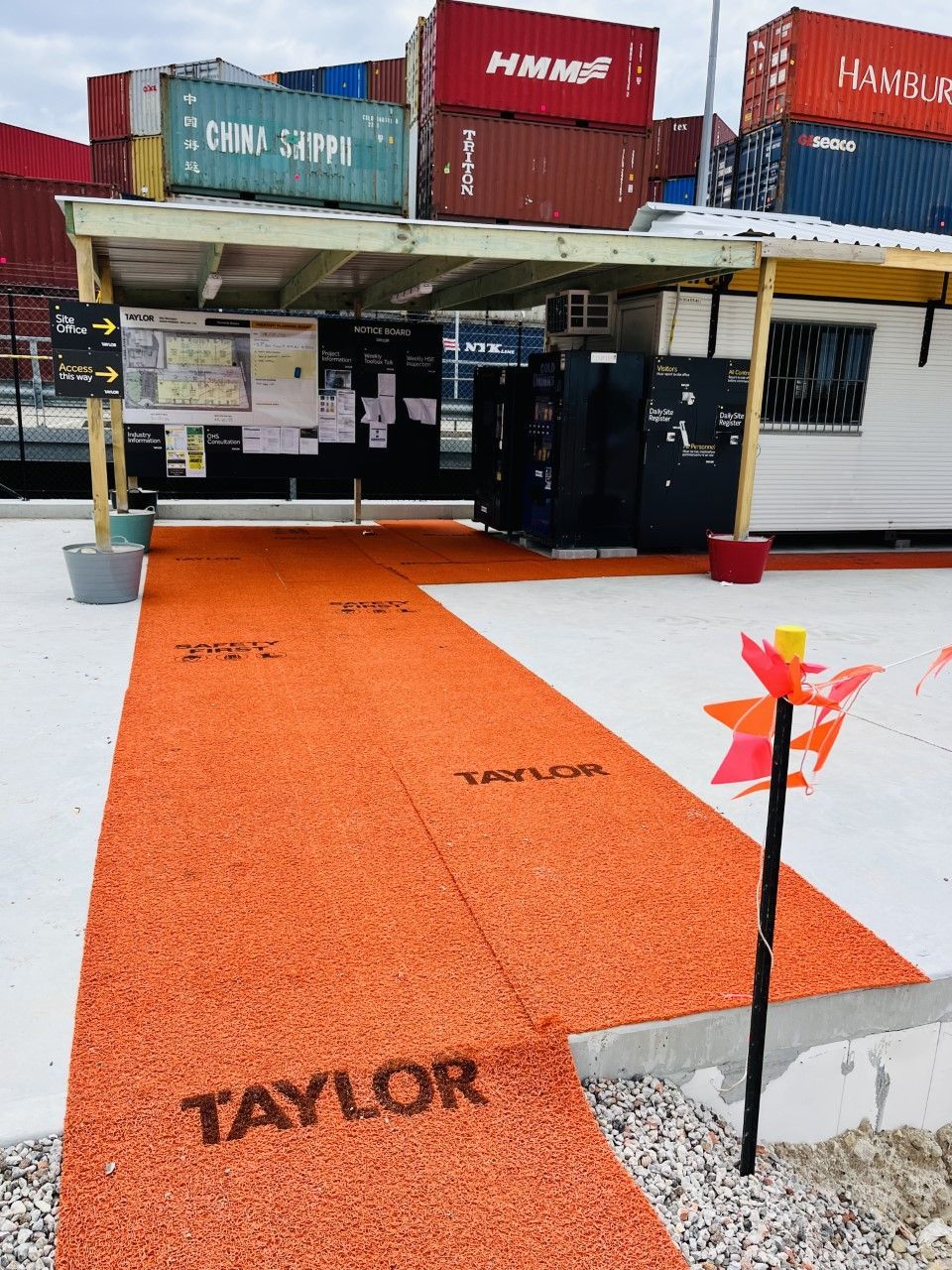 Taylor branded Boss Mat providing clear access ways to site sheds