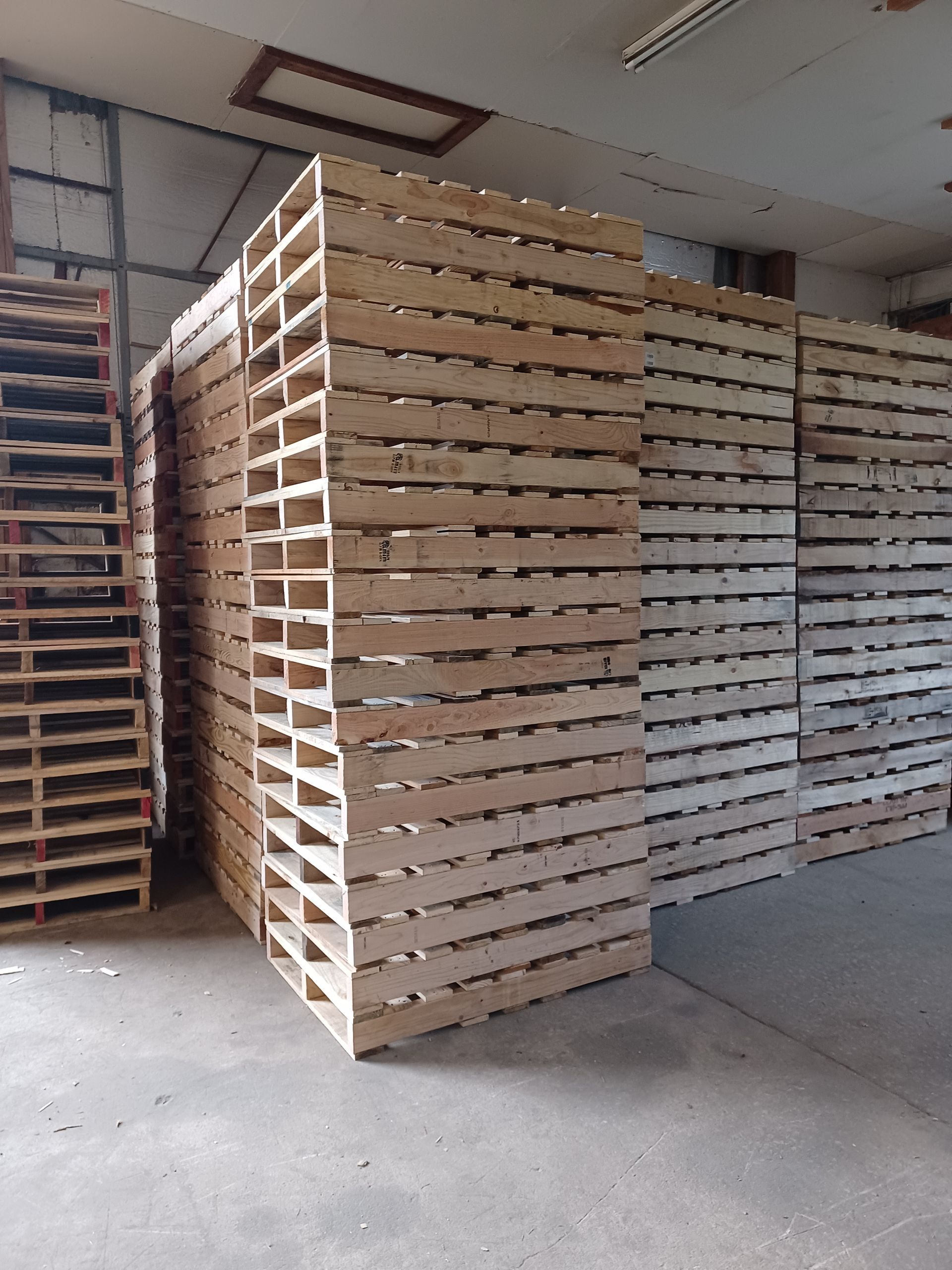a warehouse filled with lots of wooden pallets