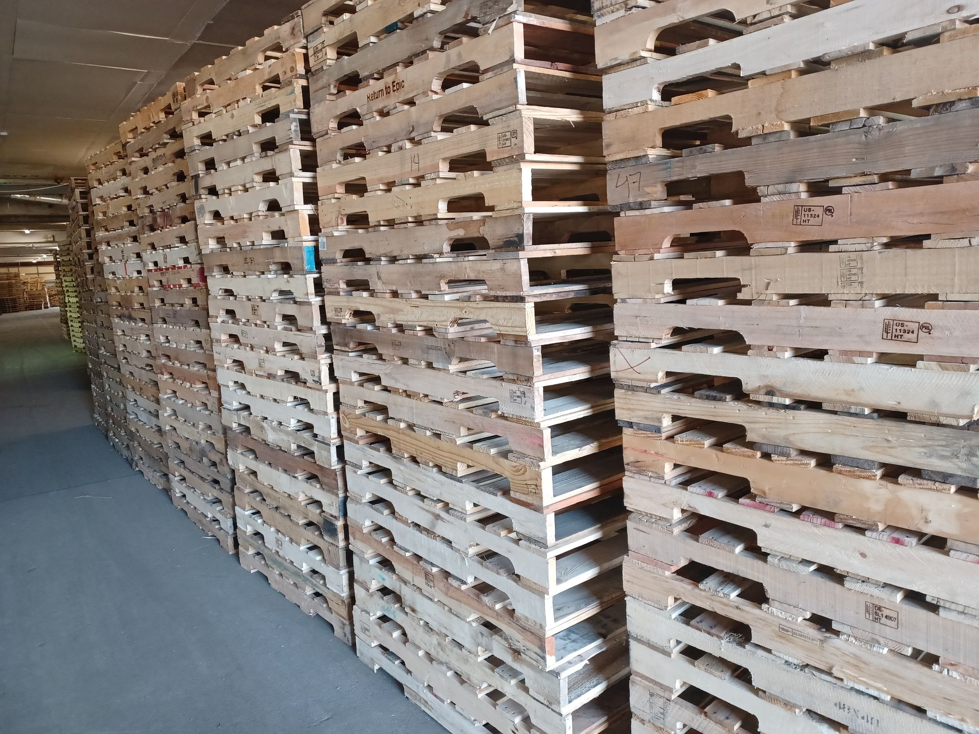 a warehouse filled with lots of wooden pallets