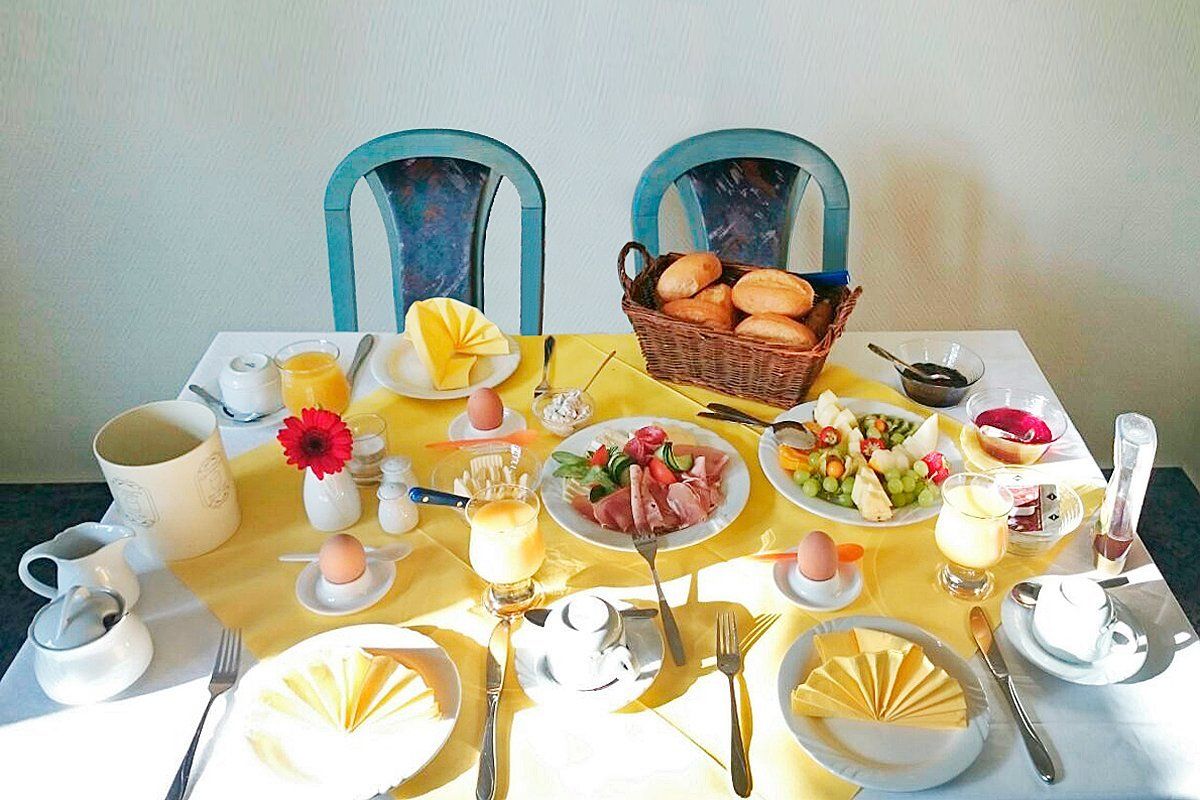 Ein Tisch mit Tellern mit Essen und Besteck darauf