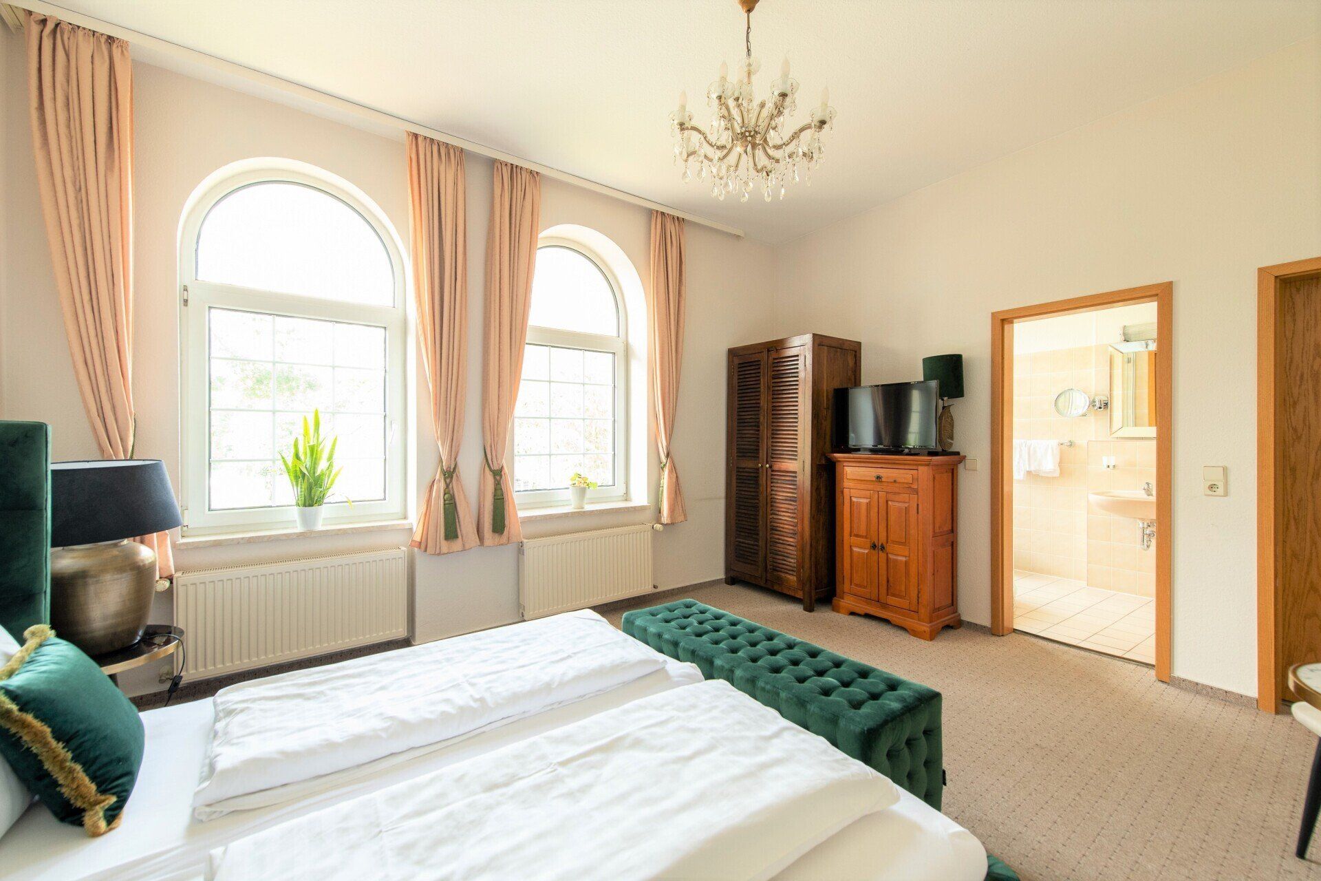 In der Mitte des Zimmers steht ein großes Bett.